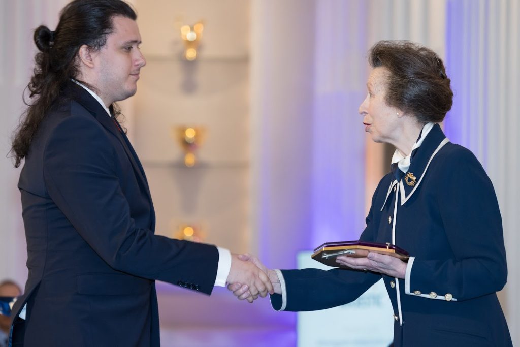 Aaron Tello-Wharton collecting the award from the Princess Royal