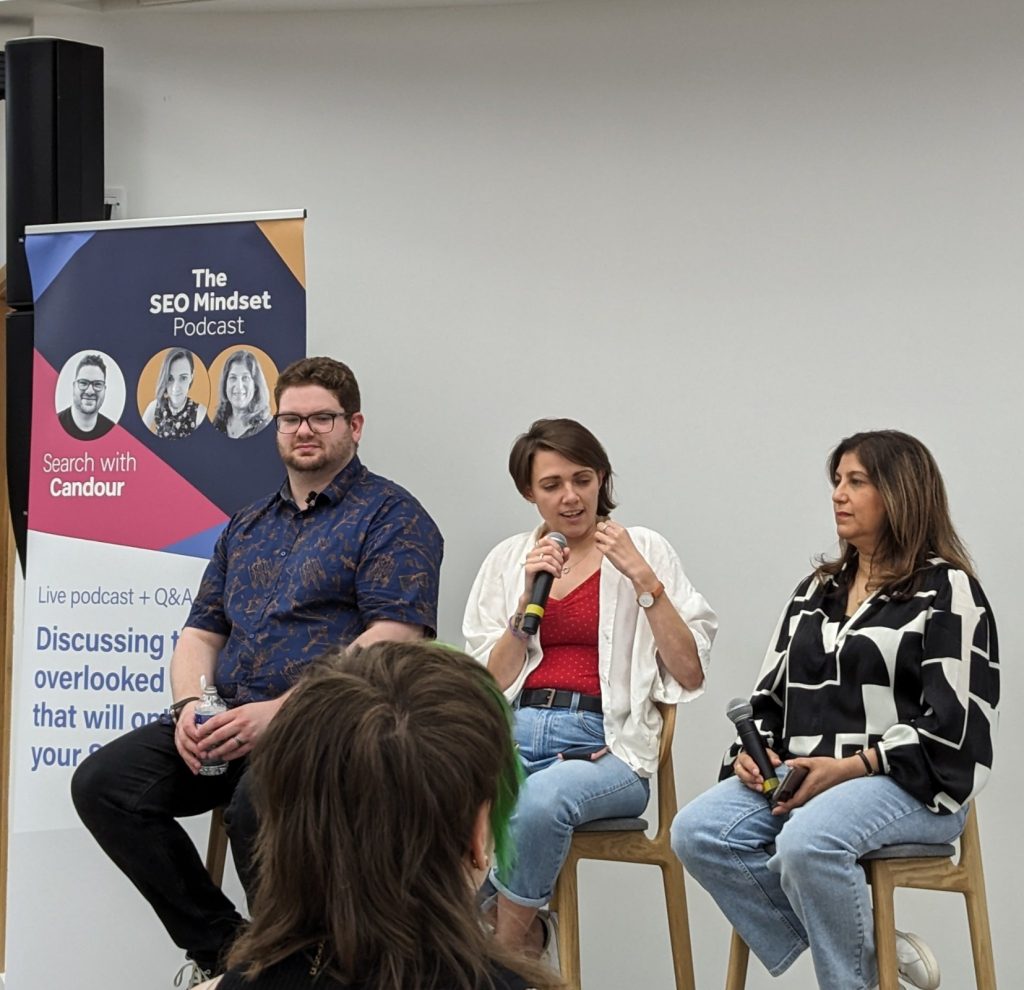 Photo taken by a Majestic employee of the hosts Sarah McDowell, Tazmin Suleman and Jack Chambers-Ward at the live recording of the SEO Mindset Podcast at brightonSEO in September, 2023.